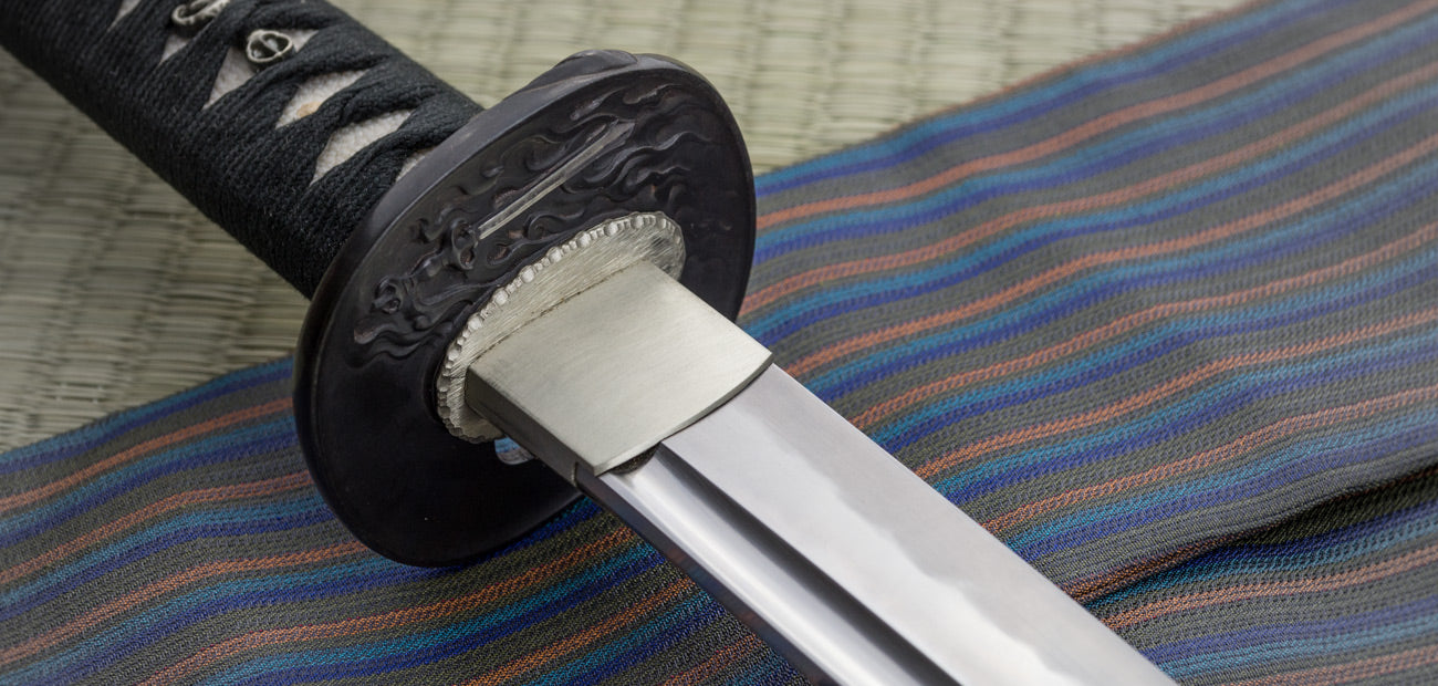 Close-up of the Savior Katana handle and tsuba, showcasing intricate design and traditional craftsmanship.