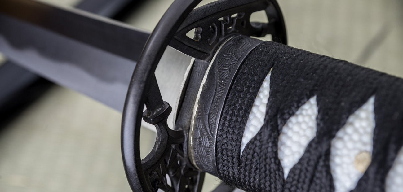 Close-up of the Yanone Katana handle and tsuba, showcasing intricate design and traditional craftsmanship.