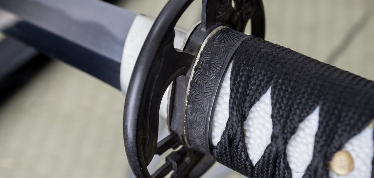 Close-up of the Yanone Katana handle and tsuba, showcasing intricate design and traditional craftsmanship.