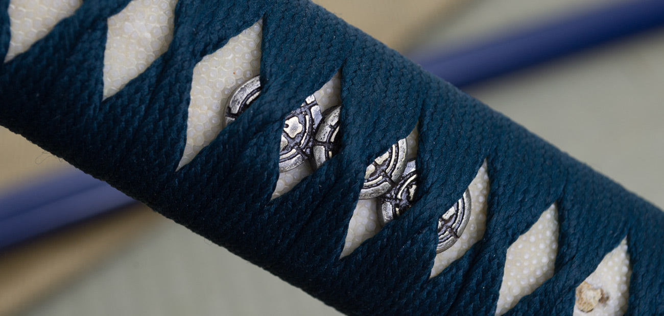 Close-up of the War Horse Katana handle and tsuba, showcasing intricate design and traditional craftsmanship.